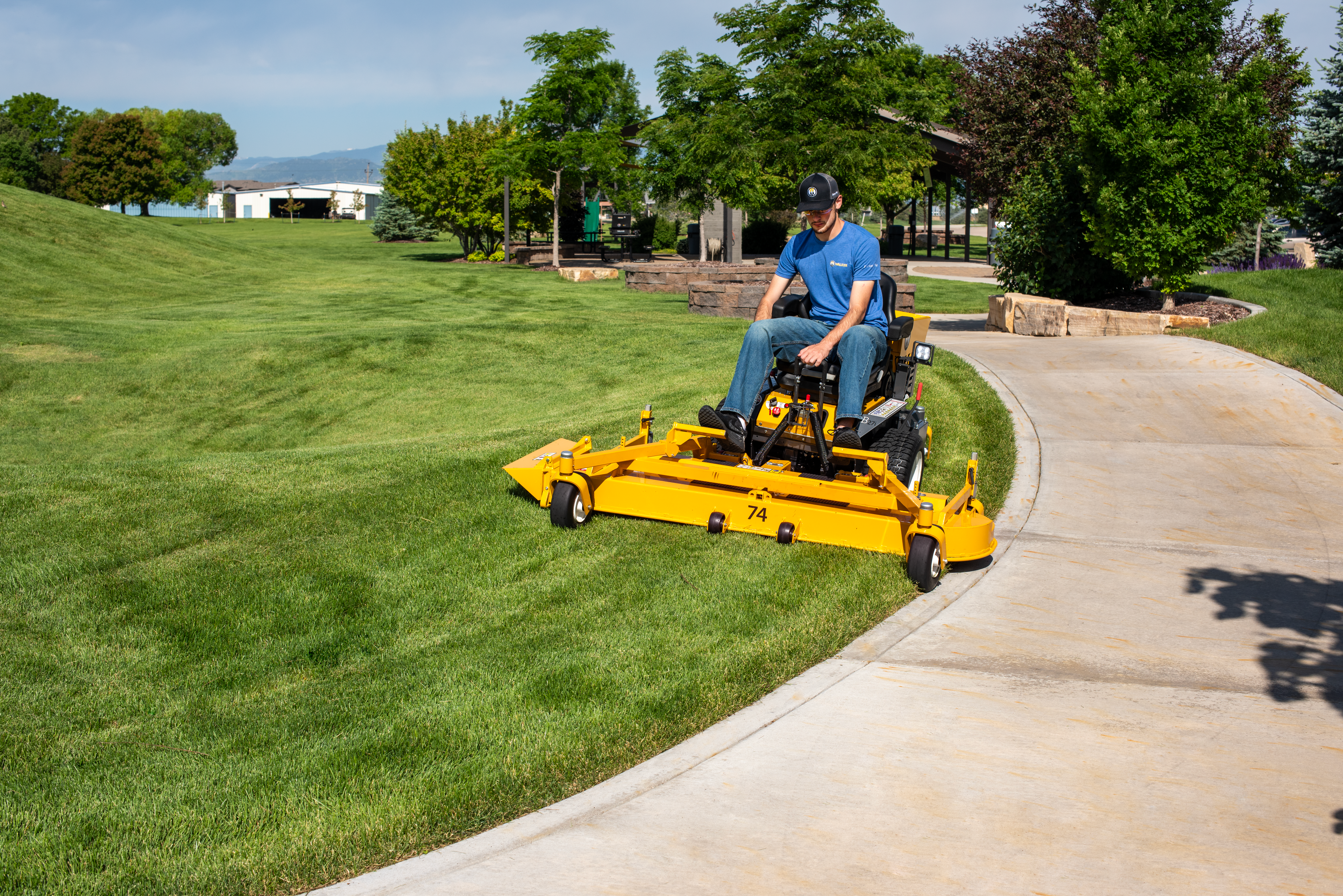Walker B27I With 74-Inch Side-Discharge Deck Mowing Beside A Pathway